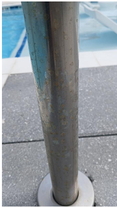 Rusting stainless steel swimming pool handrail